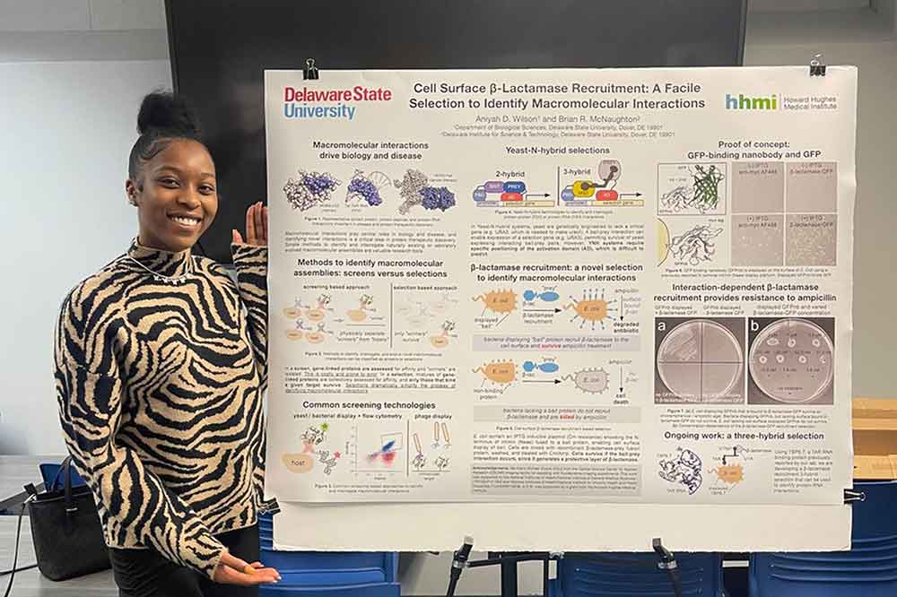 Aniyah Wilson, a sophomore Biological Science major, shows the fruits of her research she did as part of an laboratory experiential learning initiative funded by the Howard Hughes Medical Institute Inclusive Excellent Grant. Ms. Wilson and fifteen other students presented their research during a Dec. 8 Research Symposium in the Mishoe Science Center.