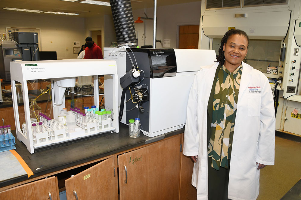Dr. Kimberly Milligan, Associate Professor of Chemistry, stands with a ICP-MS (Inductively coupled plasma mass spectrometry) system, which was an essential lab instrumentation acquisition that helped the Department's Water Analysis Lab to earn a National Environmental Laboratory Accreditation -- the first and only HBCU to have that distinction and only one of the two institutions of higher education to be so accredited. Dr. Milligan -- a three-time Delaware State University graduate (four-time if her kindergarten in the Child Lab School is counted) -- is the Director of the lab.