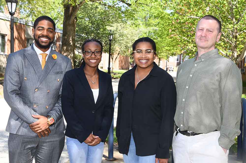 (L-r) Environmental sciences majors Jelani Bryant, Kayla McKinley and Lauren Smith have gained experience in advocating on behalf of environmental causes through their spring semester internship with the Alaska Wilderness League. Stand to their right is Dr. Kitt Heckscher, Associate Professor of Environmental Sciences, who introduced the students to the internship opportunity.