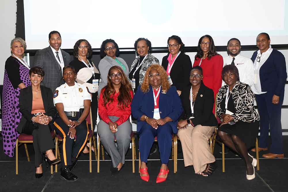 Safe Space Coalition Chairs pose for a photo during the Conference. (L-r bottom) Dr. Dawn Mosley, Lt. Joi Simmons, Rita Williams, Dr. Gwen Scott-Jones, Dr. Francine Edwards, Dr. Wanda Anderson; (top) Kim Graham, Dr. LaShawne Pryor, Latoya Anderson, Mijrane Belizaire, Annette Turlington, Pamela Mosley Gresham, Dr. Michelle Fisher, David Hawkins, and Shenequa Harris. 