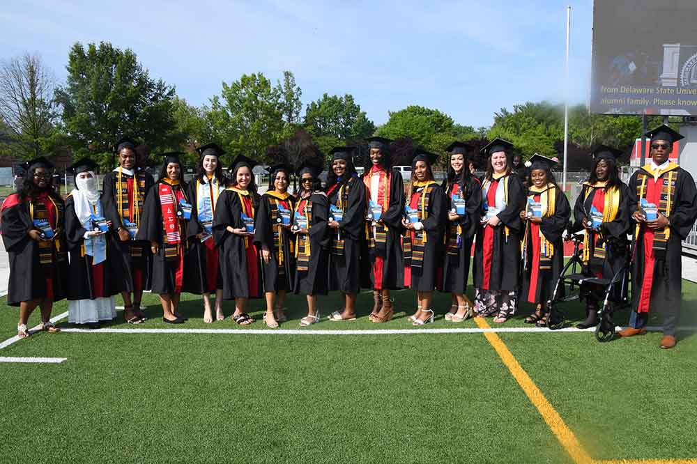 Sixteen of the school-record 21 Presidential Academic Award recipients pose for a photo during the Commencement Ceremony.