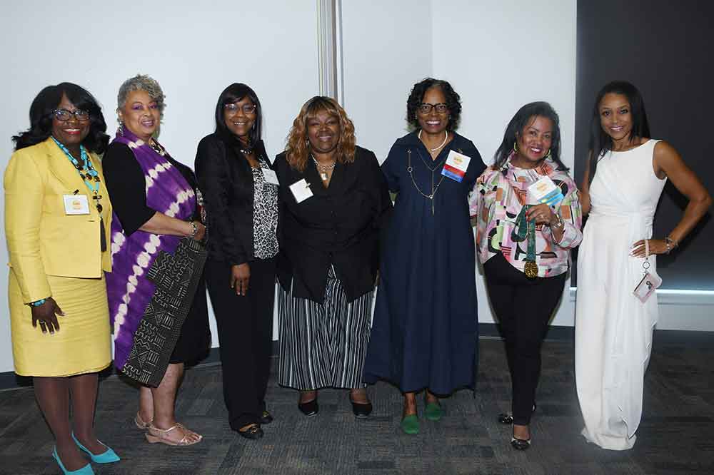 (L-r) DSU's Enid Wallace-Simms, Kim Graham, Taja Jones, Leandra Casson Marshall, Dr. Debbie Harrington, and Dr. Devona Williams pose with Olympic gold medalist Dominique Dawes, who spoke May 18 on campus during a health conference.