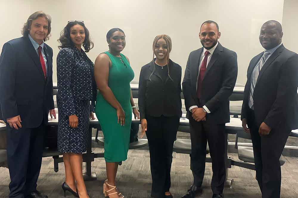 Joyce Kasiama (3rd from right), winner of the University's 11th annual Speech Competition, poses with (l-r) Dr. Sam Hoff, tournament coordinator, and the judges: Jordan Perry, Alexis Turner Garris, Vernon Vassallo and Joshua Brooks, all from the Delaware Barristers Association. The topic of the competition was "If Dr. Martin L. King Jr. were alive, would he favor slavery reparations, and if so, how would he suggest reparation be financed and issued." 