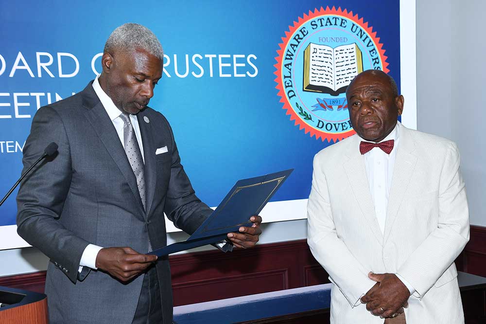 University Board of Trustees Chairman Leroy Tice administers the oath of office to new Board member William "Bill" Collick, who is the winningest head football coach (81-48 from 1985-1996) in DSU history and also served as the institution's Athletics Director for four years. Mr. Collick was appointed to the trustee seat by Gov. John Carney.