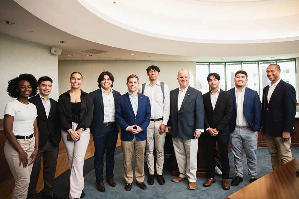 Tom Gayner (4th from the right) poses with the College of Business' Investment Club, which has received a 25-year commitment from Mr. Gayner to spread a $125,000 over annual payments in that period to the organization. In addition to the initial year's $5,000, the Investment Club has also received $30,000 from the Markel Corporation, of which Mr. Gayner is the CEO.