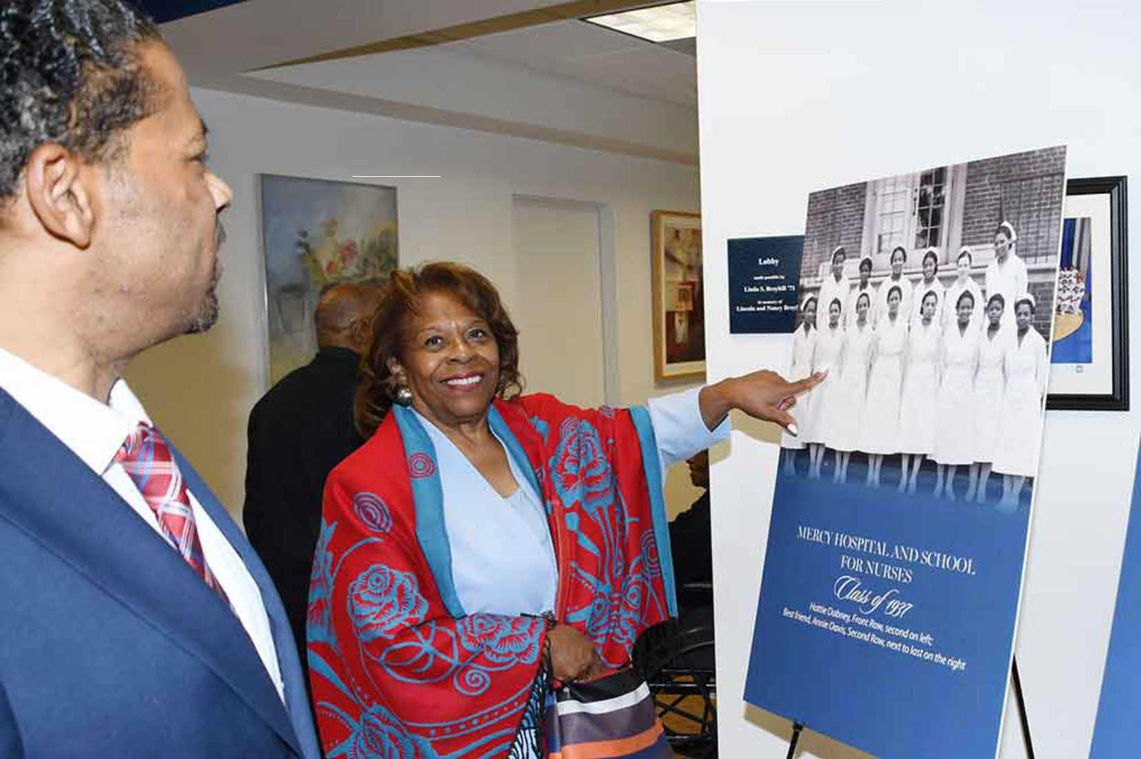 Past DSU President Dr. Wilma Mishoe points out her mother Hattie Dabney Mishoe in her Mercy Douglas School of Nursing graduation picture on display in the building that now bears her name -- the Hattie Dabney Mishoe Nursing Hall.