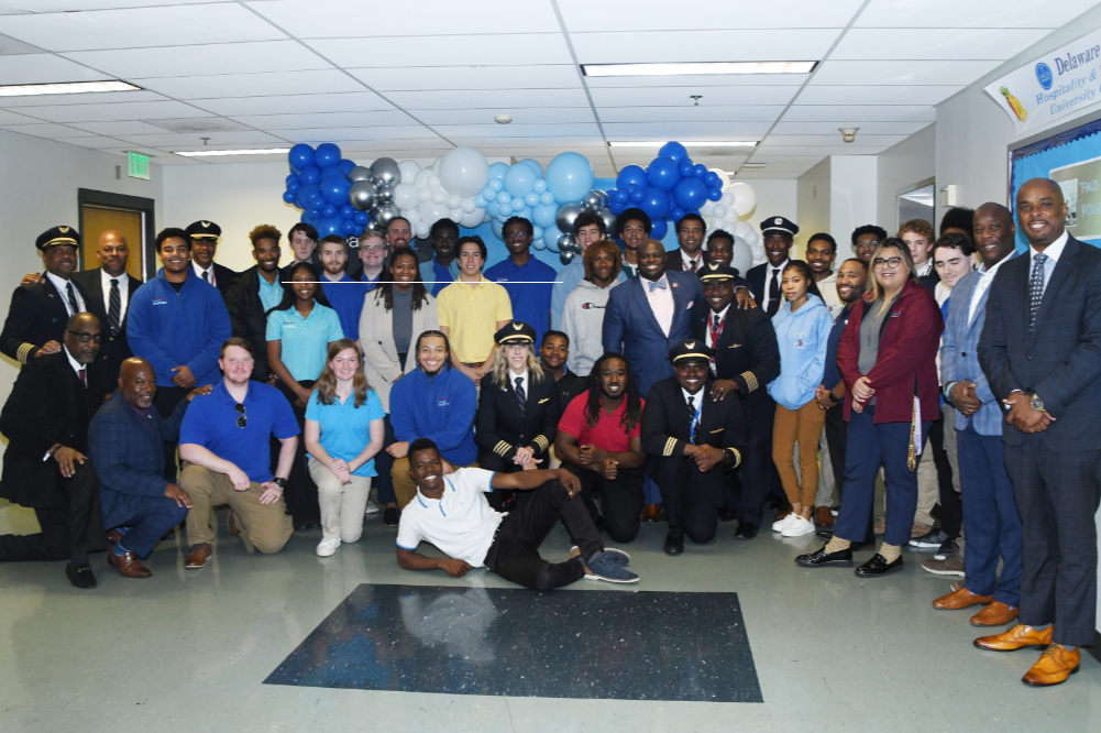 A group of United Airlines pilots, DSU Aviation Program students and University administrators gather for a celebratory group photo after Delaware State University formally entered into a partnership agreement with the airline and its Aviate Program, which will give DSU Professional Pilot students a direct path to become United pilots.