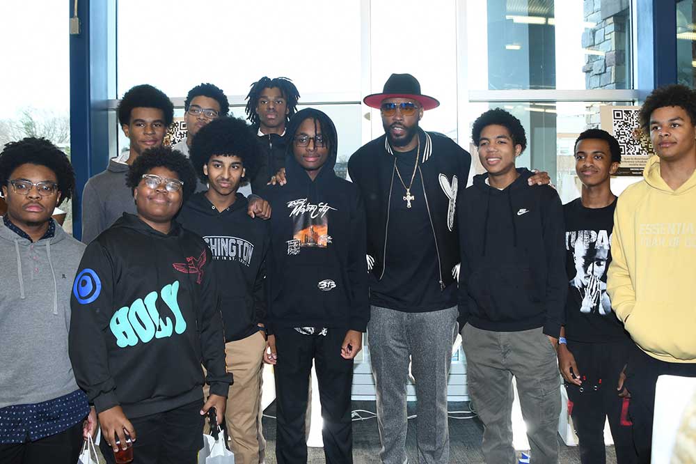 After his keynote address at the Black Male Initiative Conference in the MLK Jr. Student Center, author, pastor and recording artist Montell Jordan (with the hat) posed with a group of the young high school students who attended the daylong event.