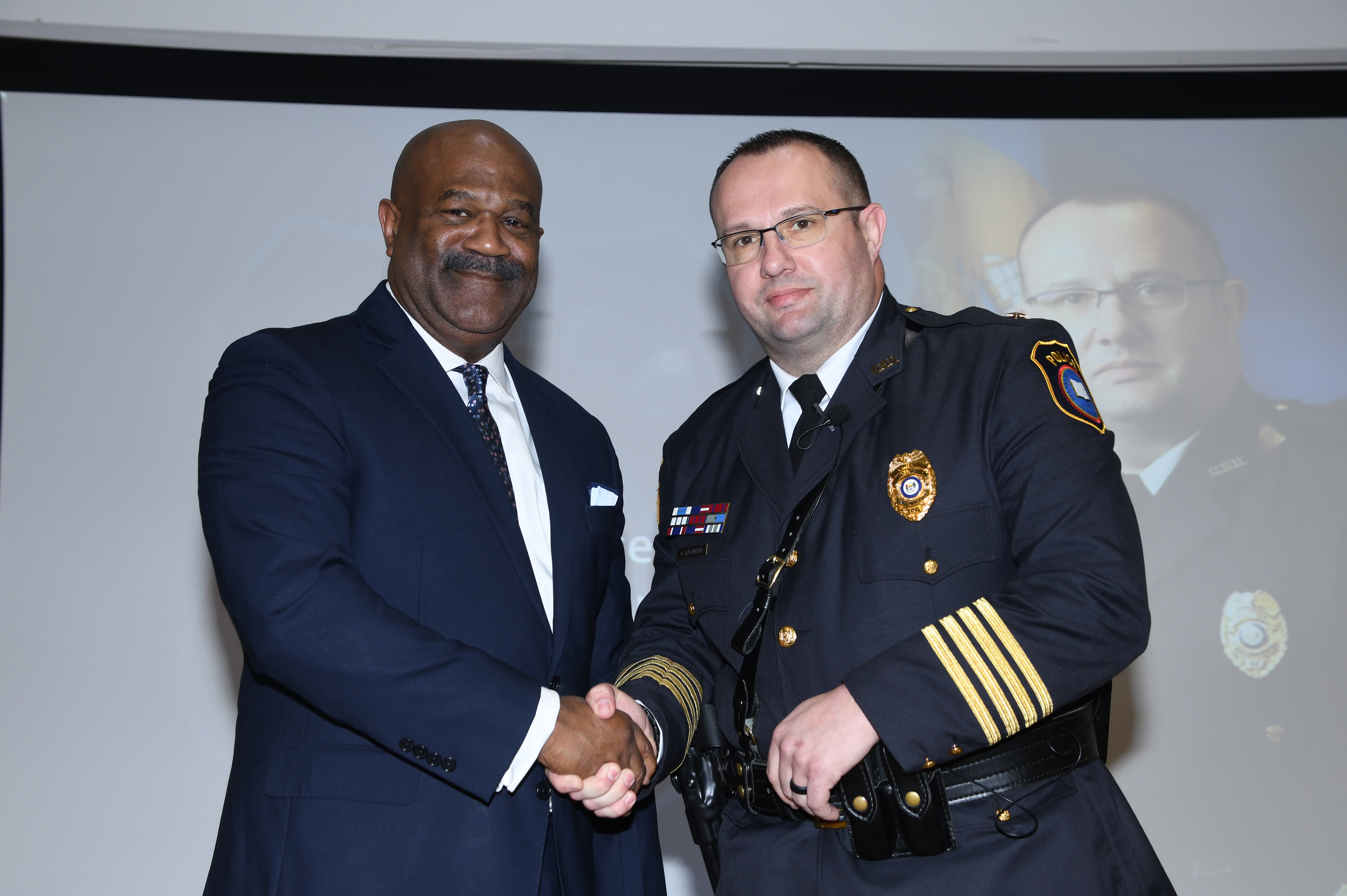 Newly sworn in Superintendent/Vice President James Overton and Chief of Police/Assistant Vice President Donald Baynard shake hands after taking the oath of their promotions during the DSU Police Department Change of Command, Promotions and Awards Ceremony.