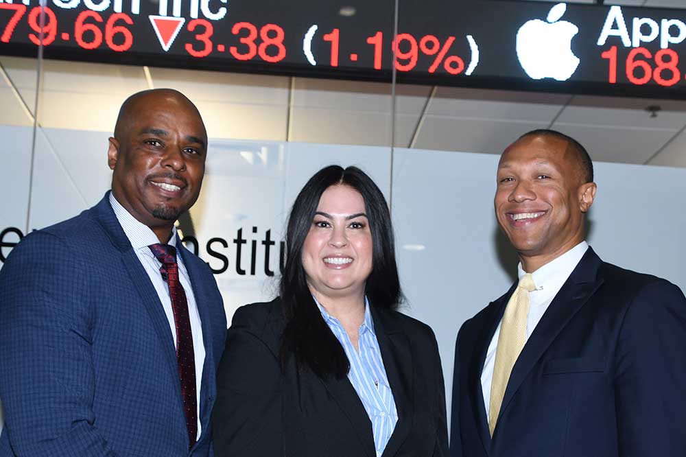(L-r) College of Business Dean Michael Casson; Sherri Trombley, Director of Advisor Services, Business Consulting & Education at Charles Schwab; and Greg Coverdale, Director of the Charles Schwab Financial Literacy Institute, pose for a photo after the ribbon cutting ceremony.
