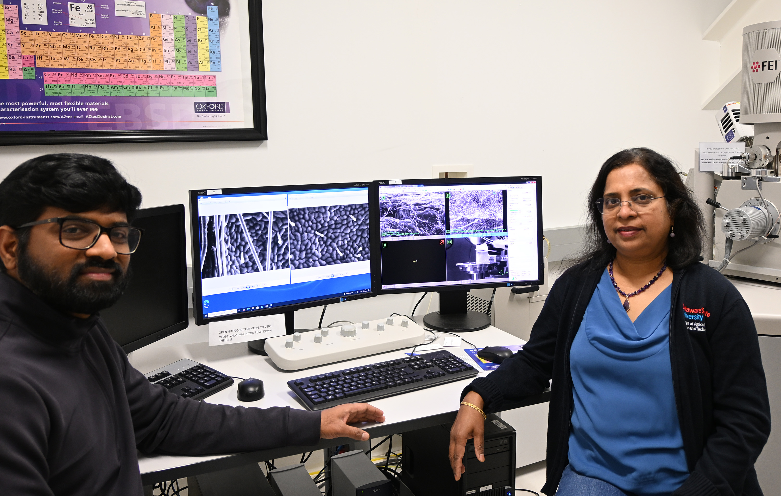 Dr. Amaranatha R. Vennapusa, a post-doctoral associate, and the senior author of the study, and Dr. Kalpalatha Melmaiee, Associate Professor of the Department of Agriculture and Natural Resources, pose at computers where they are observing the strawberry leaf trichomes in the OSCAR Imaging facility.