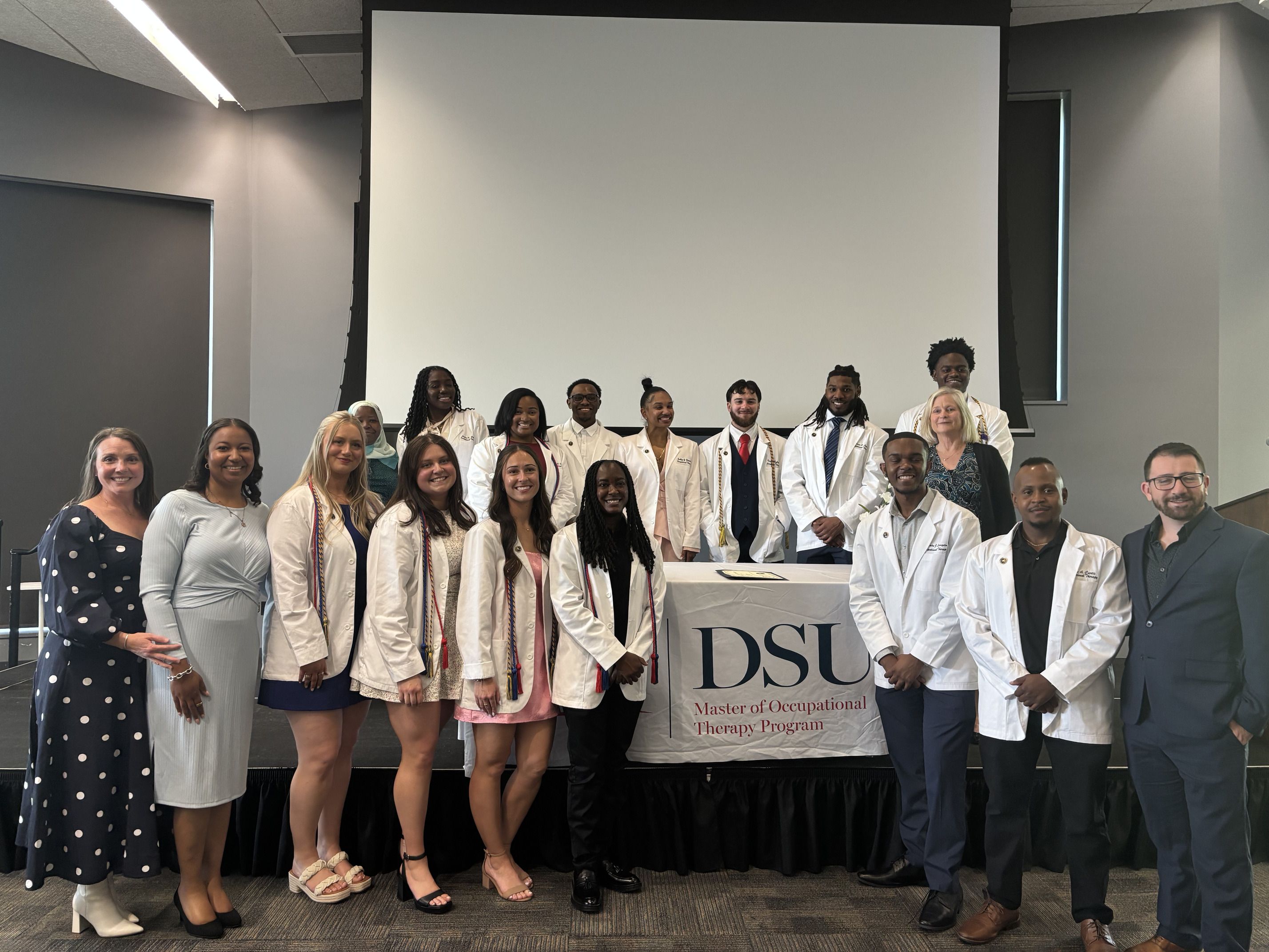 Students and faculty from Delaware State University’s Master of Occupational Therapy Program gather for a group photo during the program’s Pinning Ceremony celebrating students as they advance in their professional and clinical training.