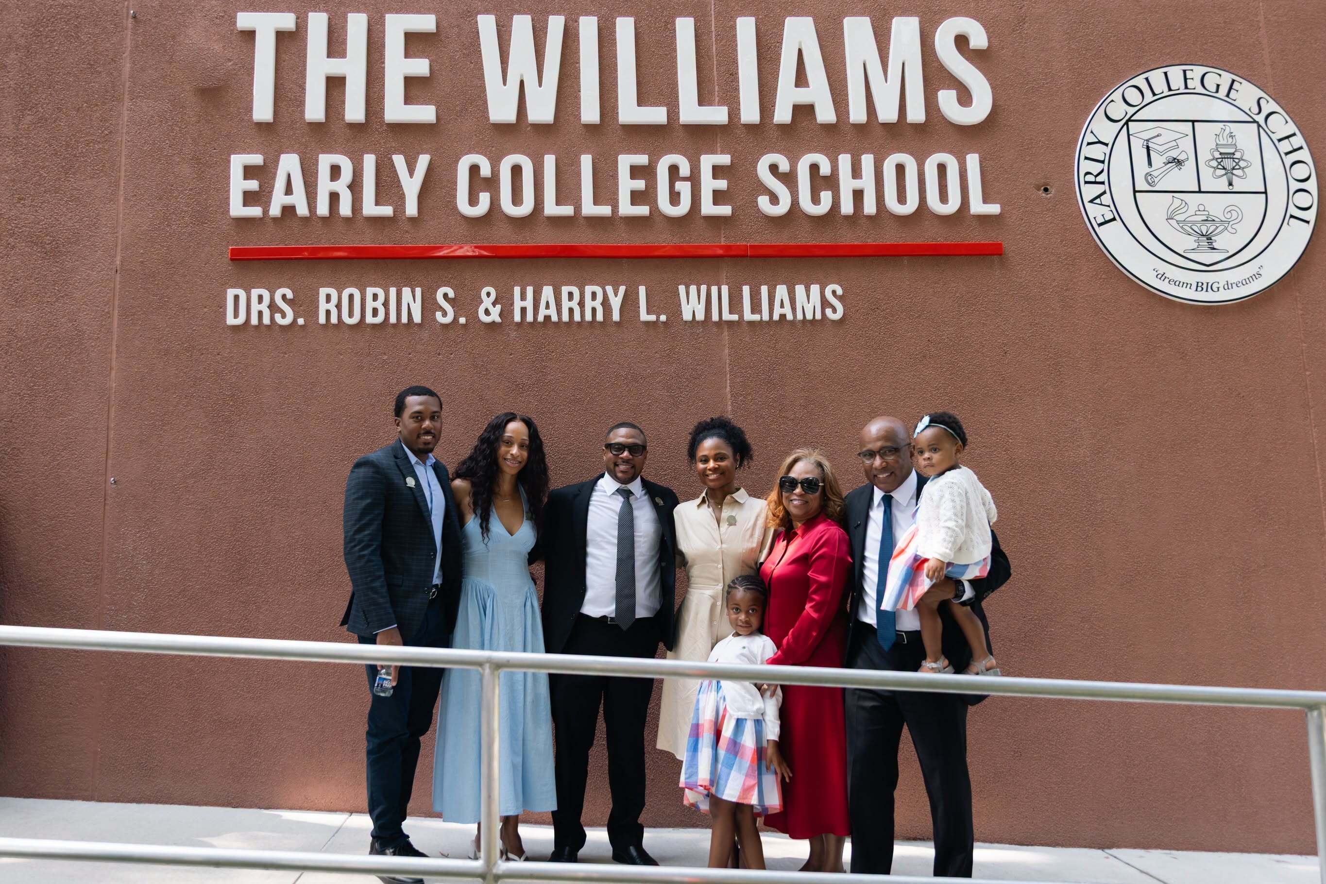 Dr. Robin Williams and former Delaware State University President Dr. Harry L. Williams, right, gather with family in front of the newly named Williams Early College School.