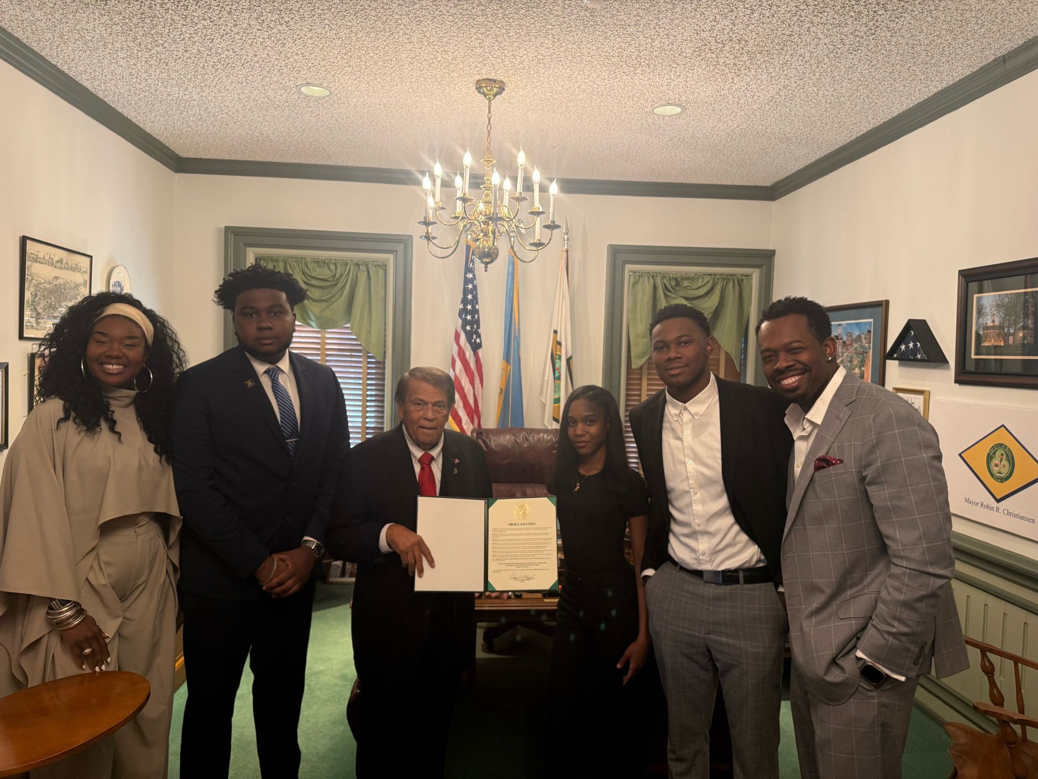 Delaware State University junior Zafyr K. Ahmad (second from left), founder and president of the University's first Black Law Student Association, joins Dover Mayor Robin R. Christiansen (third from left) and fellow supporters as the mayor presents an official proclamation recognizing the establishment of the new student organization.