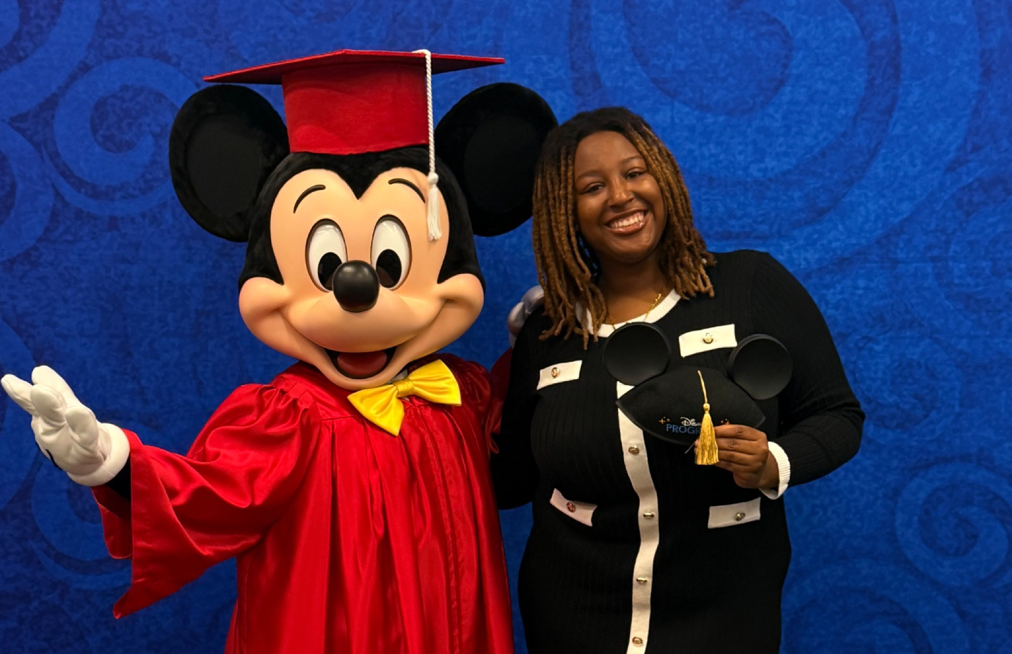 Delaware State University student Nevaeh Terry poses with Mickey Mouse during her Disney College Program experience at Walt Disney World Resort.