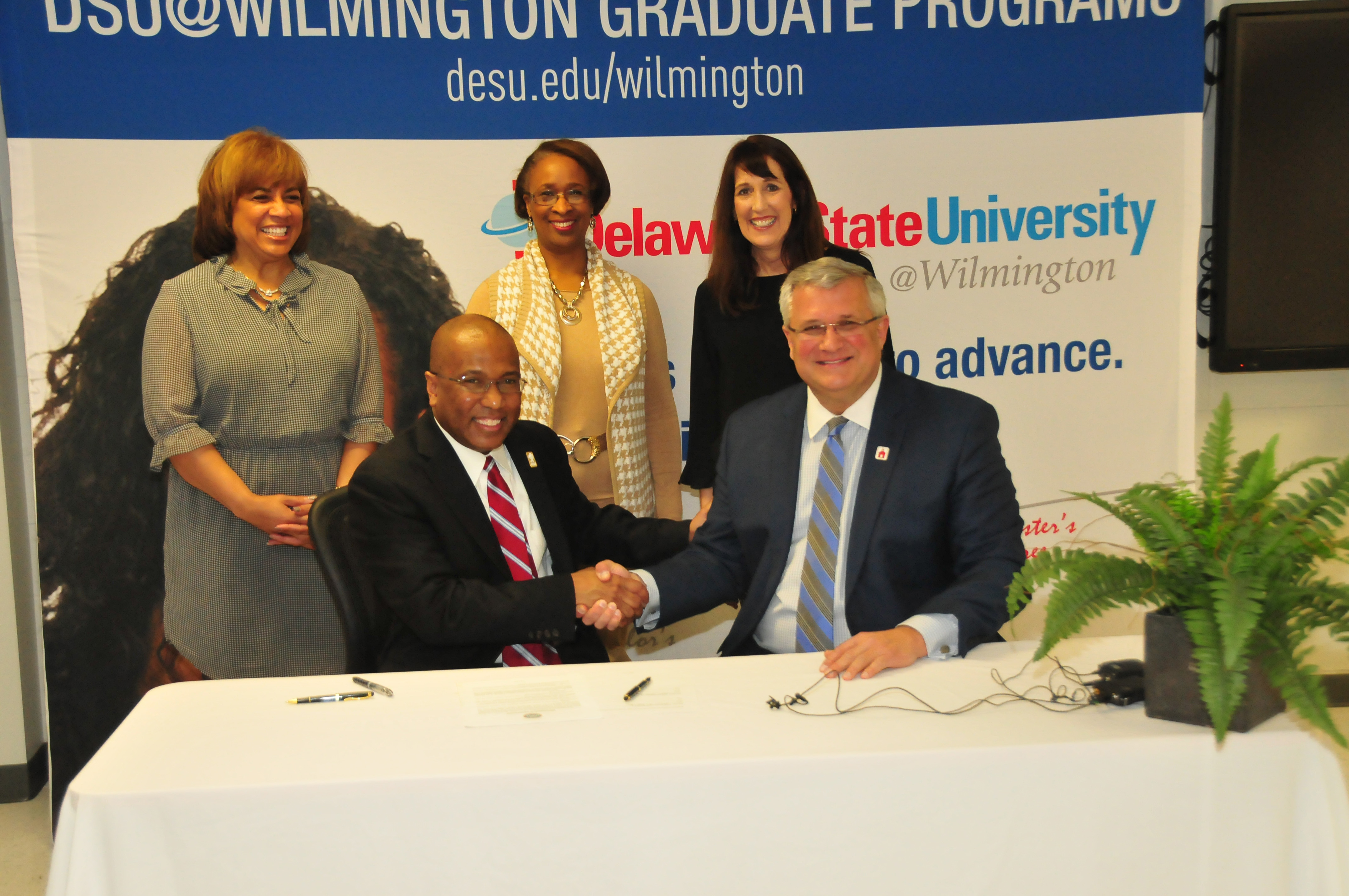DSU President Harry L. Williams shakes hands with Red Clay School District Superintendent Merv Daugherty after signing an agreement to offer IT courses to high school students at DSU@Wilmington. 