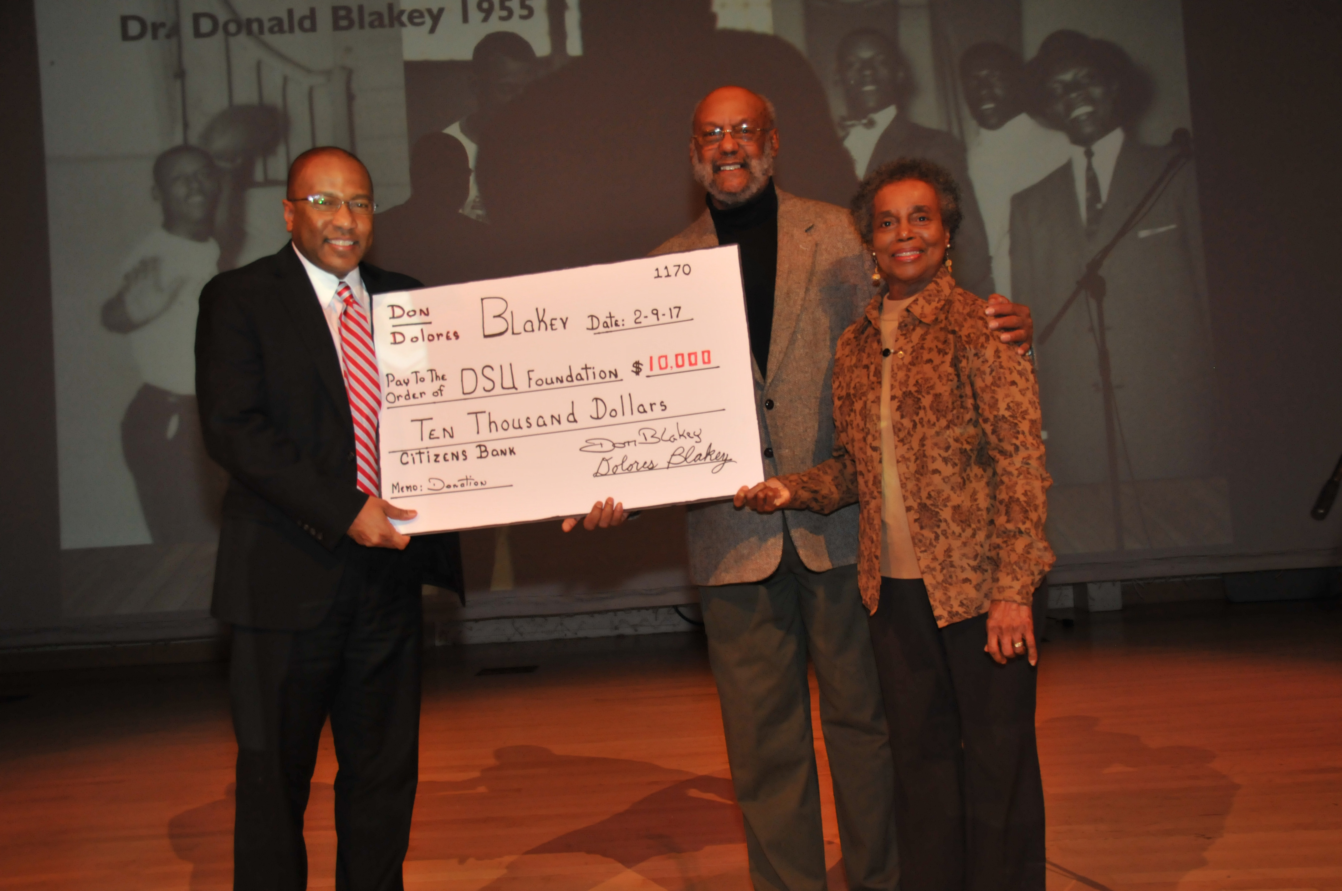DSU President Harry L. Williams holds up a symbolic check representing a donation of $10,000 by Dr. Donald and Dolores Blakey (right and center), classes of 1958 and 1962, respectively. The check was presented during the Feb. 9 Founders Day Program.