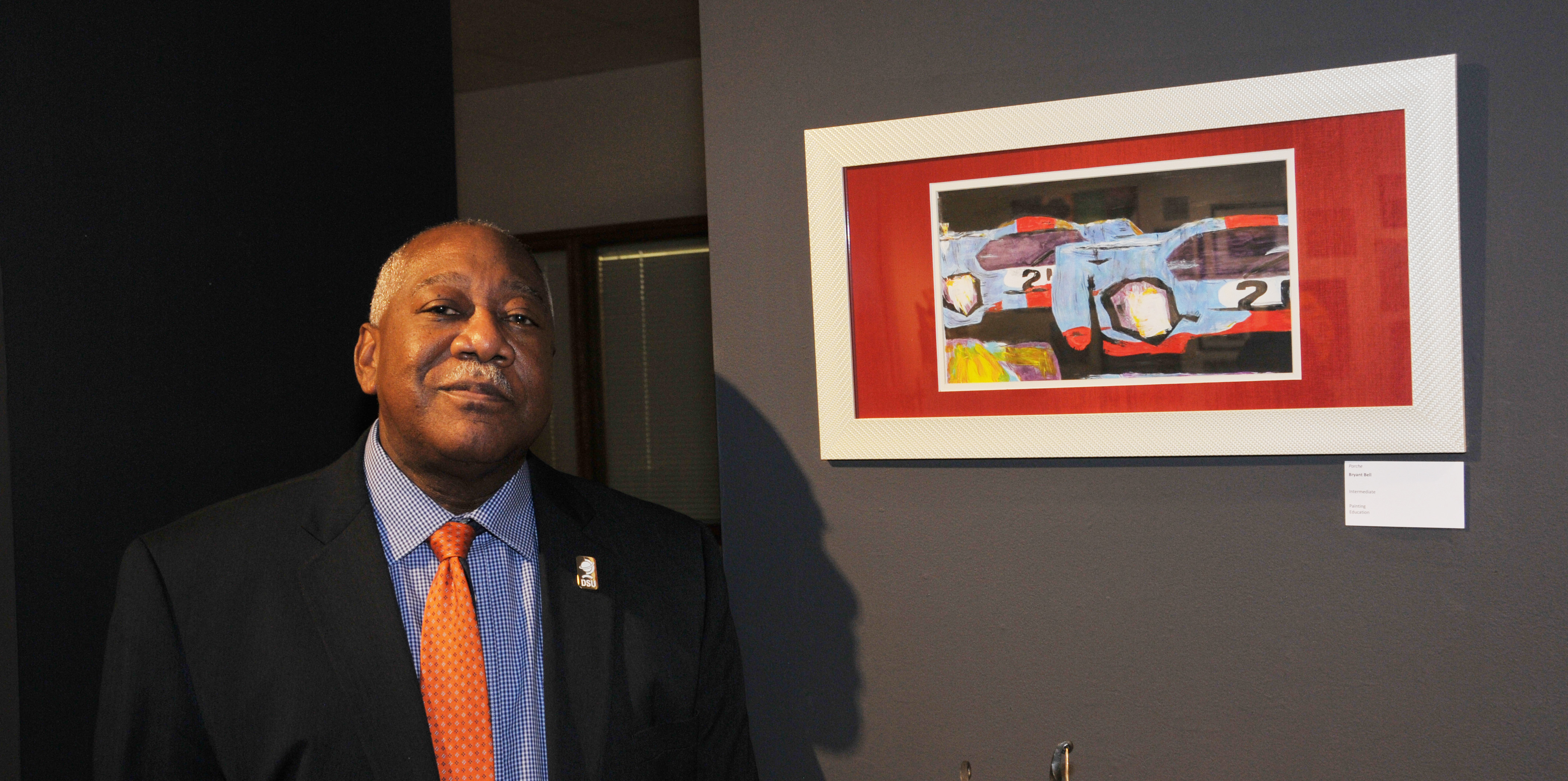 Bryant T. Bell stands with his acrylic painting "Porsche" that is part of the exhibition.