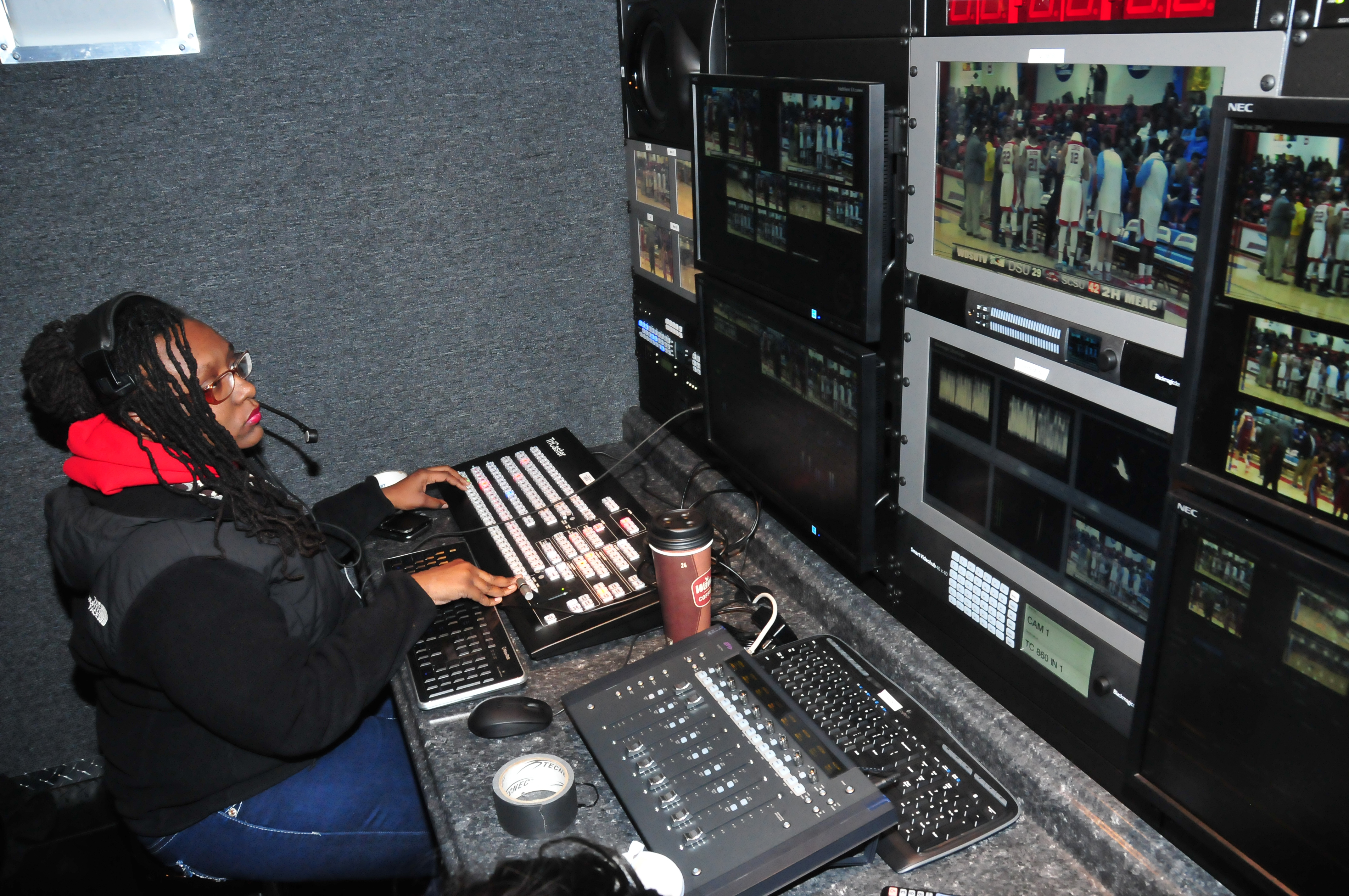 Jasmine Alford works a Hornet basketball game in the Mobile Video Production Trailer. The production trailer has reduced the set-up time for the students and provided them with an excellent hand-on experience environment.