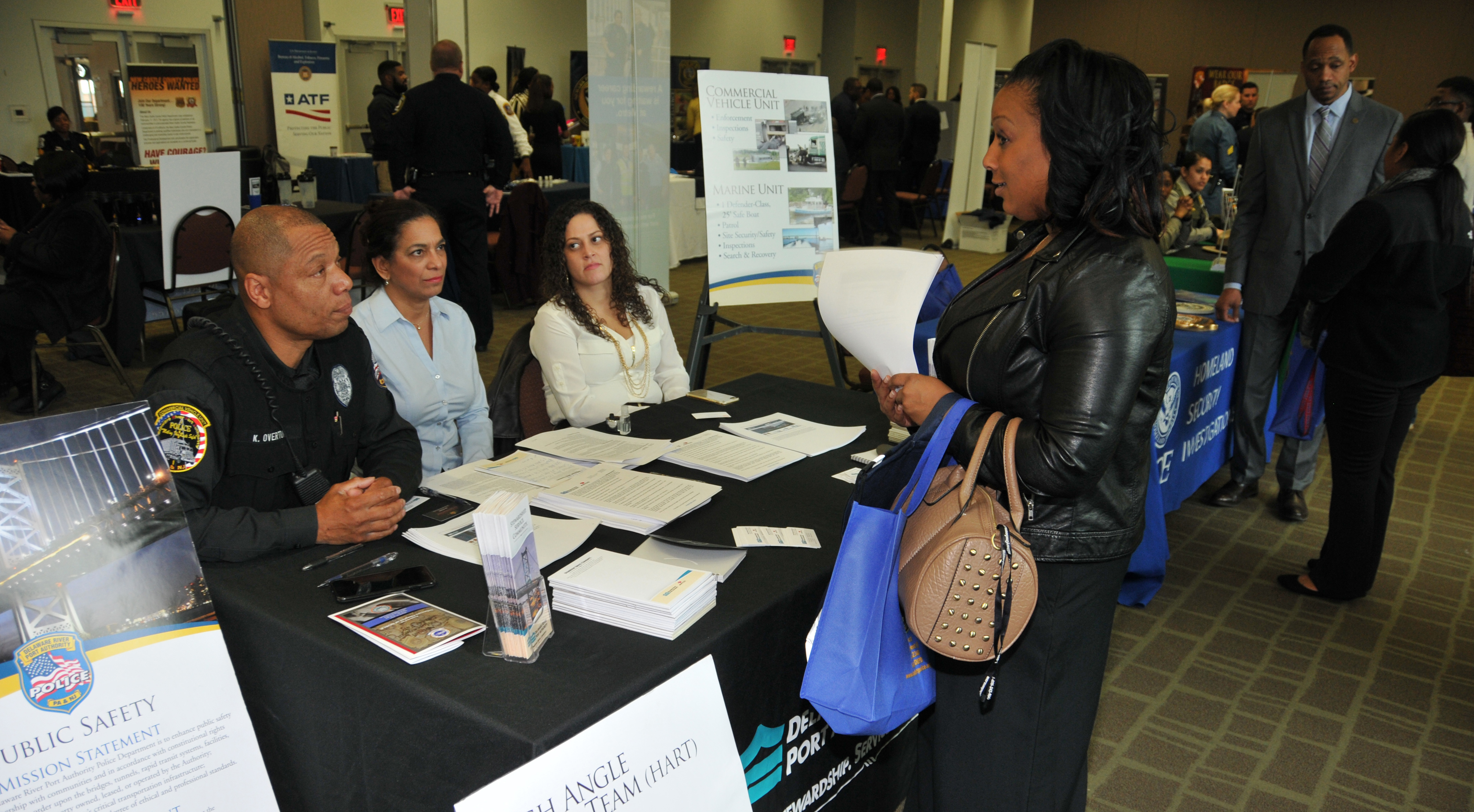 An attendee of the NOBLE Career Fair get some information from the Delaware River and Port Authority representatives.