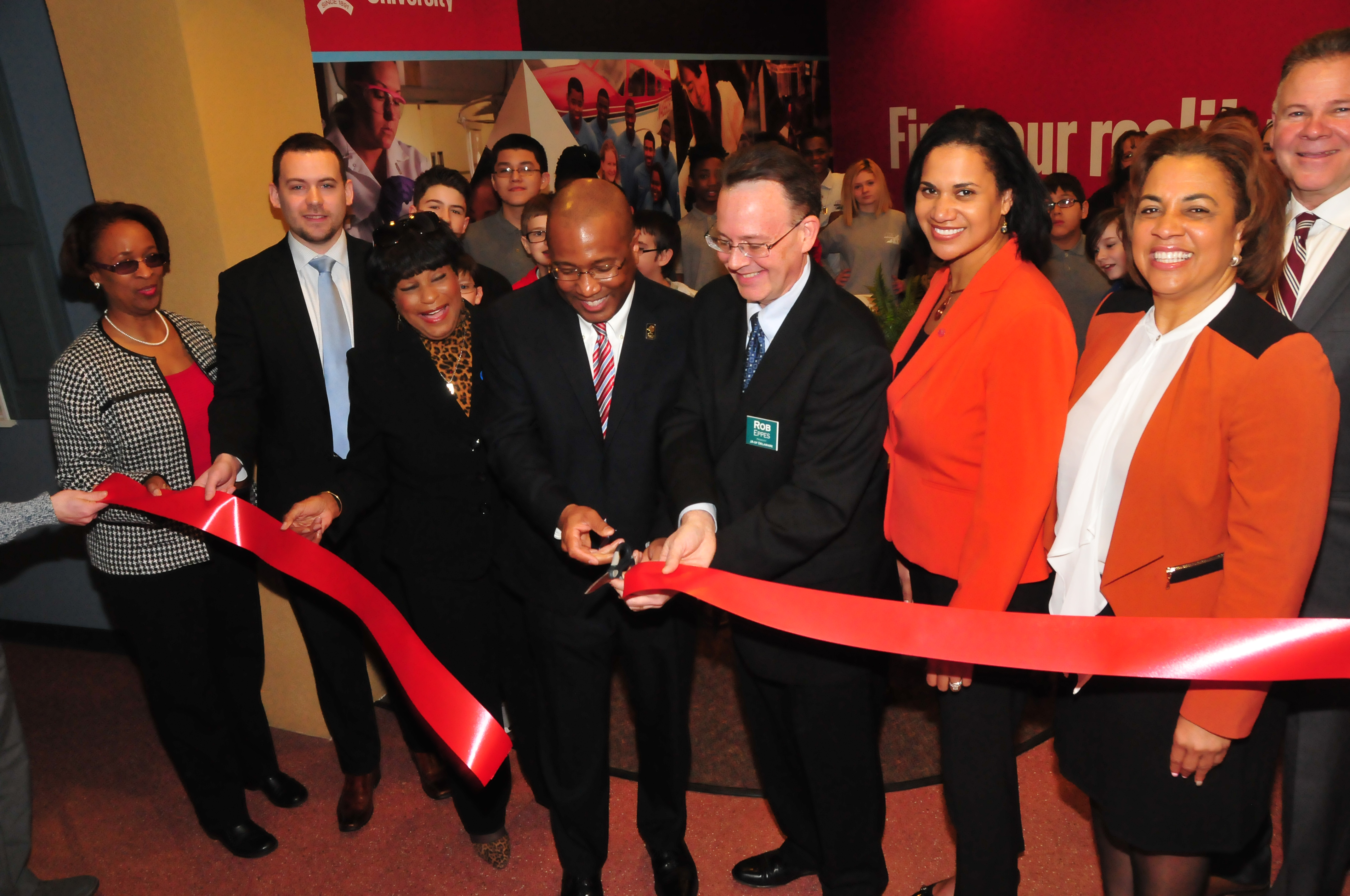 Participating in the ribbon cutting of the new Delaware State University section of the Junior Achievement Financial Bank in Wilmington are: (l-r) Dr. Marshá Horton, dean of the DSU College of Education, Health and Public Policy; Bryan P. Gordon, deputy chief of staff for Lt. Gov.; state Rep. Stephanie T. Bolden; DSU President Harry L. Williams; Robert Eppes, president of Junior Achievement of Delaware; Dr. Kara Odom Walker, Secretary of Delaware Health and Social Services; Valerie Dinkins, special asst. to the DSU president; and Michael Carney, JA development director