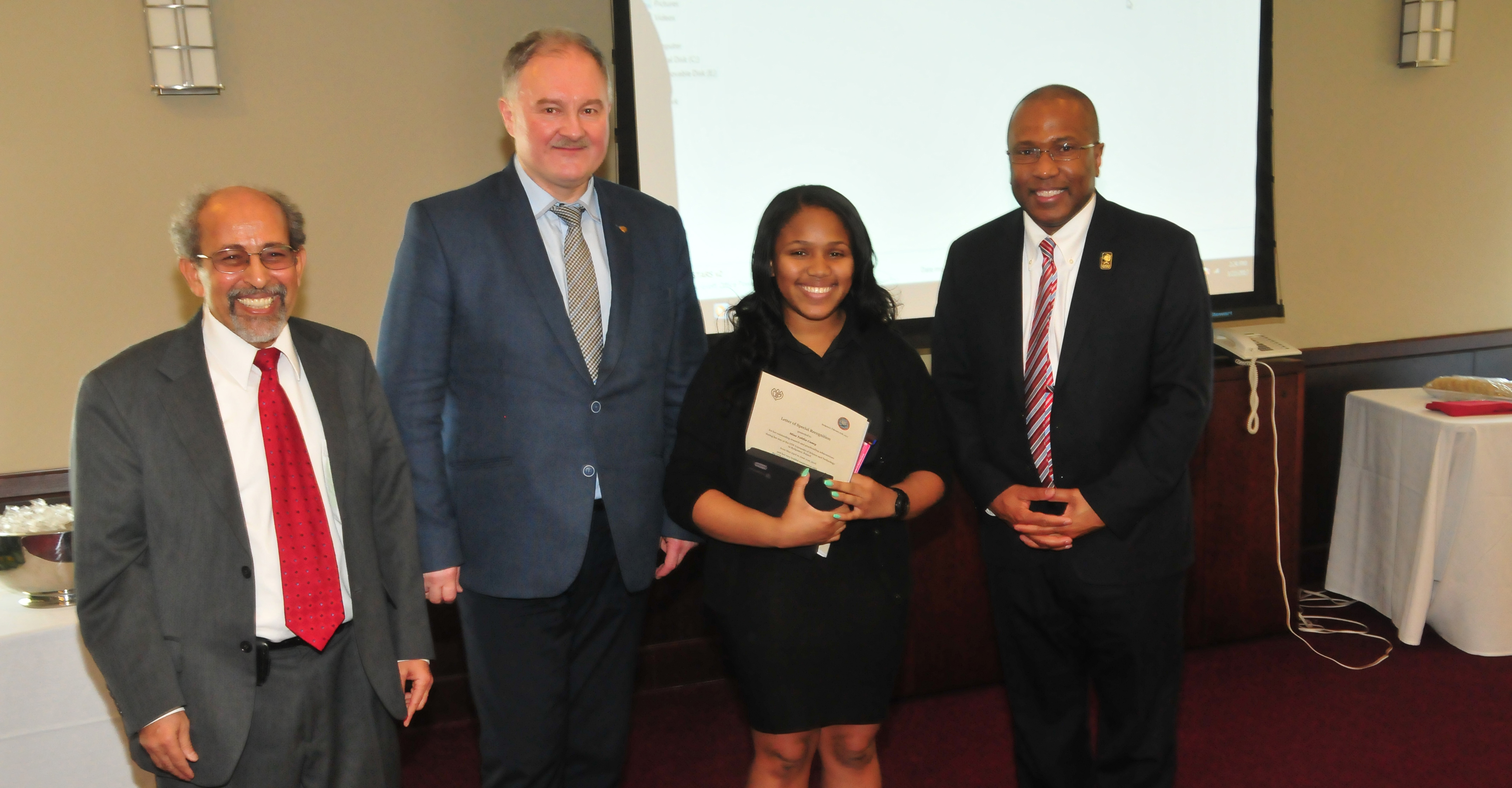 (L-r) Dr. Mazen Shahin, AMP director; Prof. Adam Gadomski, vice rector for UTP International Relations and Ms. Casey's research mentor in Poland; Tahlia Casey and DSU President Harry L. Williams. Prof. Gadomski came to DSU to present to Ms. Casey the published papers she helped co-author. 