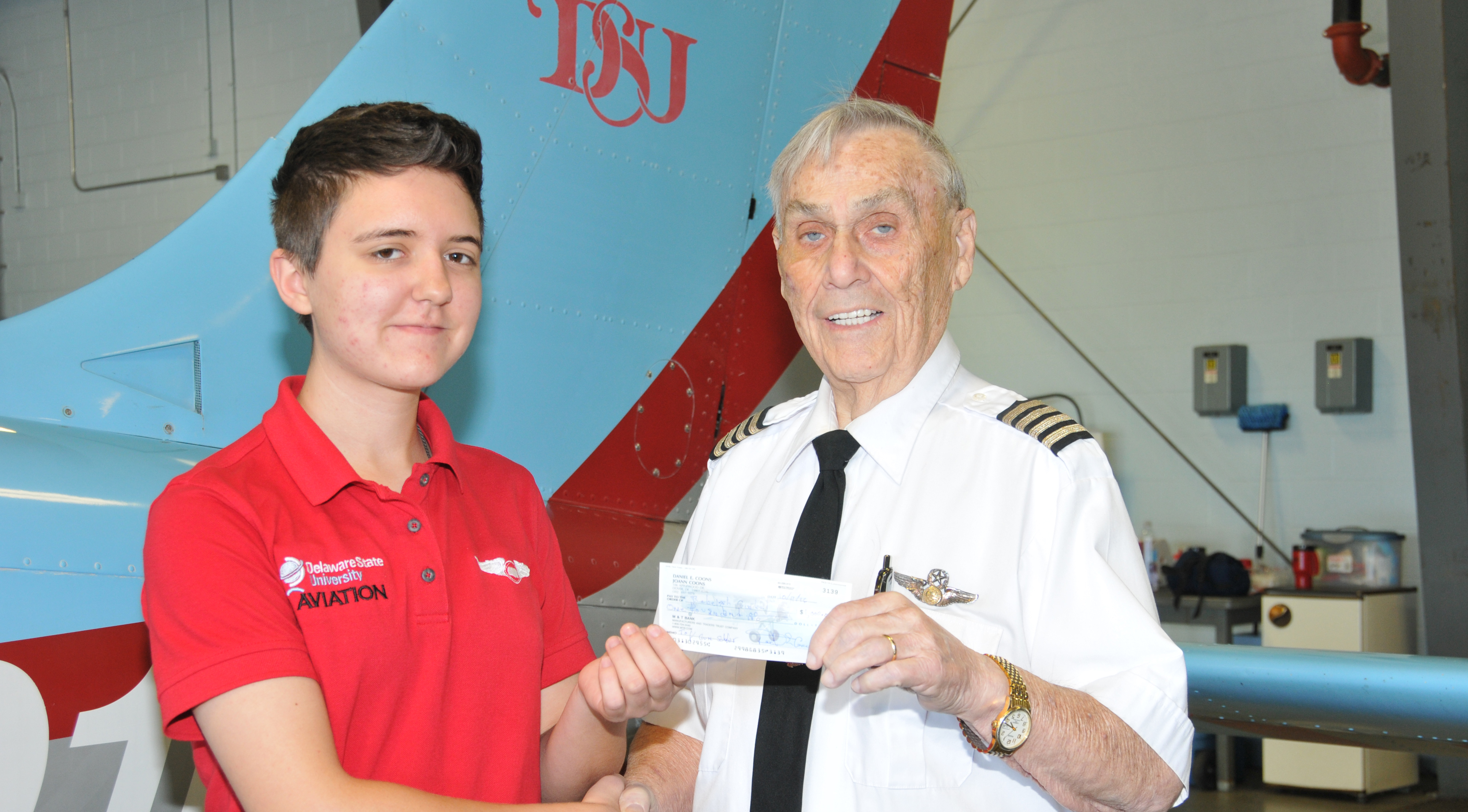 Dr. Daniel E. Coons, shown last fall presenting a scholarship check to aviation major Rebekah Goebels, passed away on May 3 after a battling cancer for several years.
