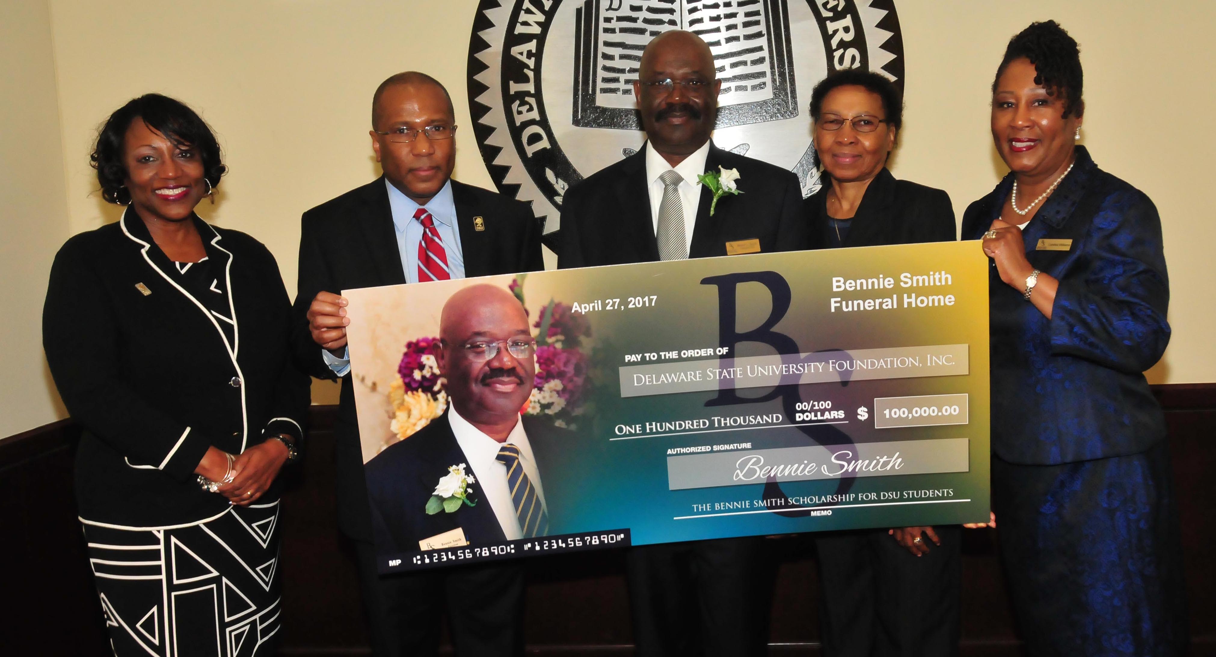 (L-r) Dr. Vita Pickrum, DSU President Harry L. Williams, Bennie and Shirley Smith, as well as Cynthia Williams of Bennie Smith Funeral Homes, pose with a display check representing the newly established endowment.