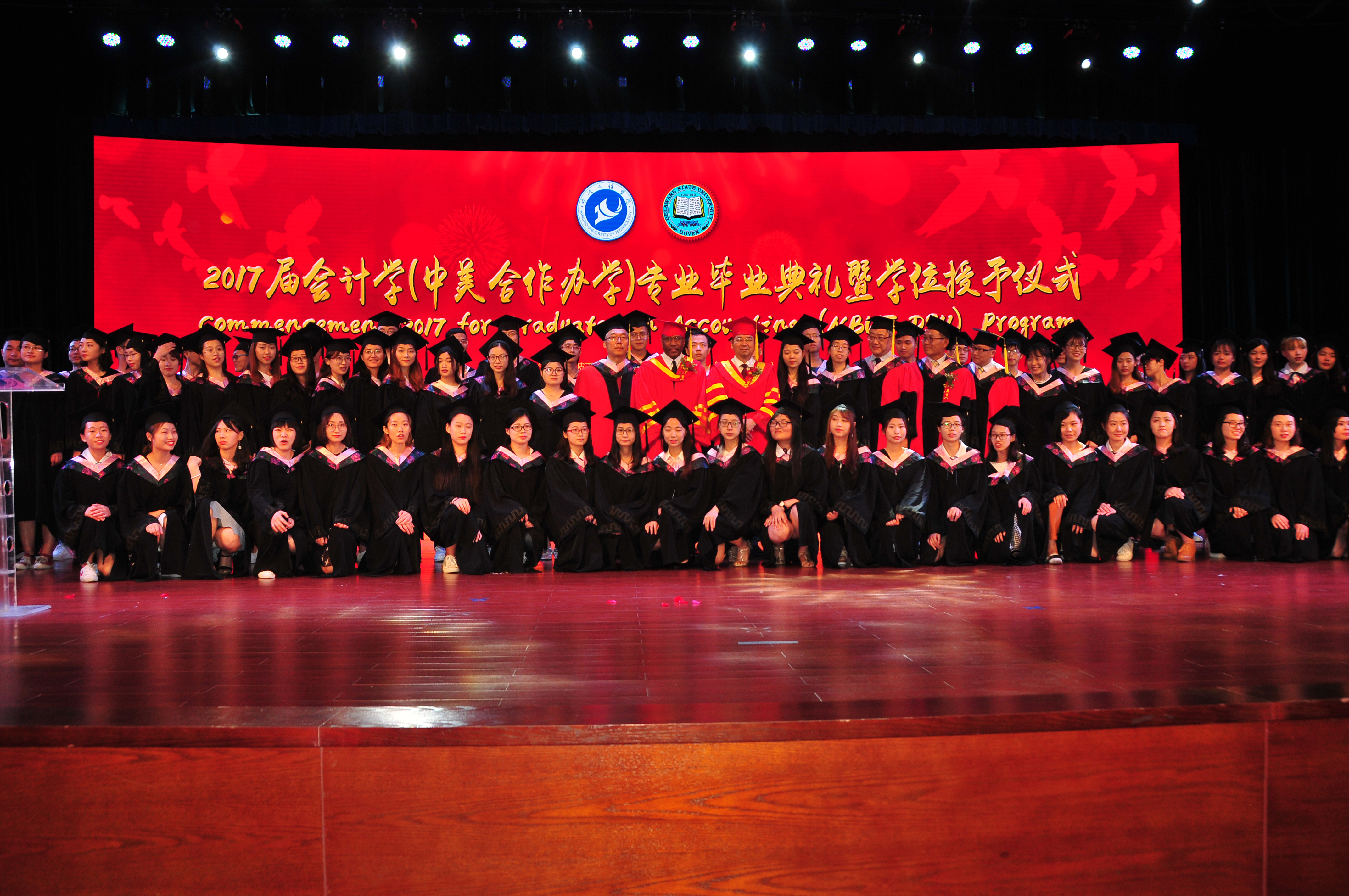 (Center) Dr. Fengshan Liu, DSU President Harry L. Williams and NBUT President Lyn Zhongda pose with the 81-member class of graduates from the DSU-NBUT Accounting Program