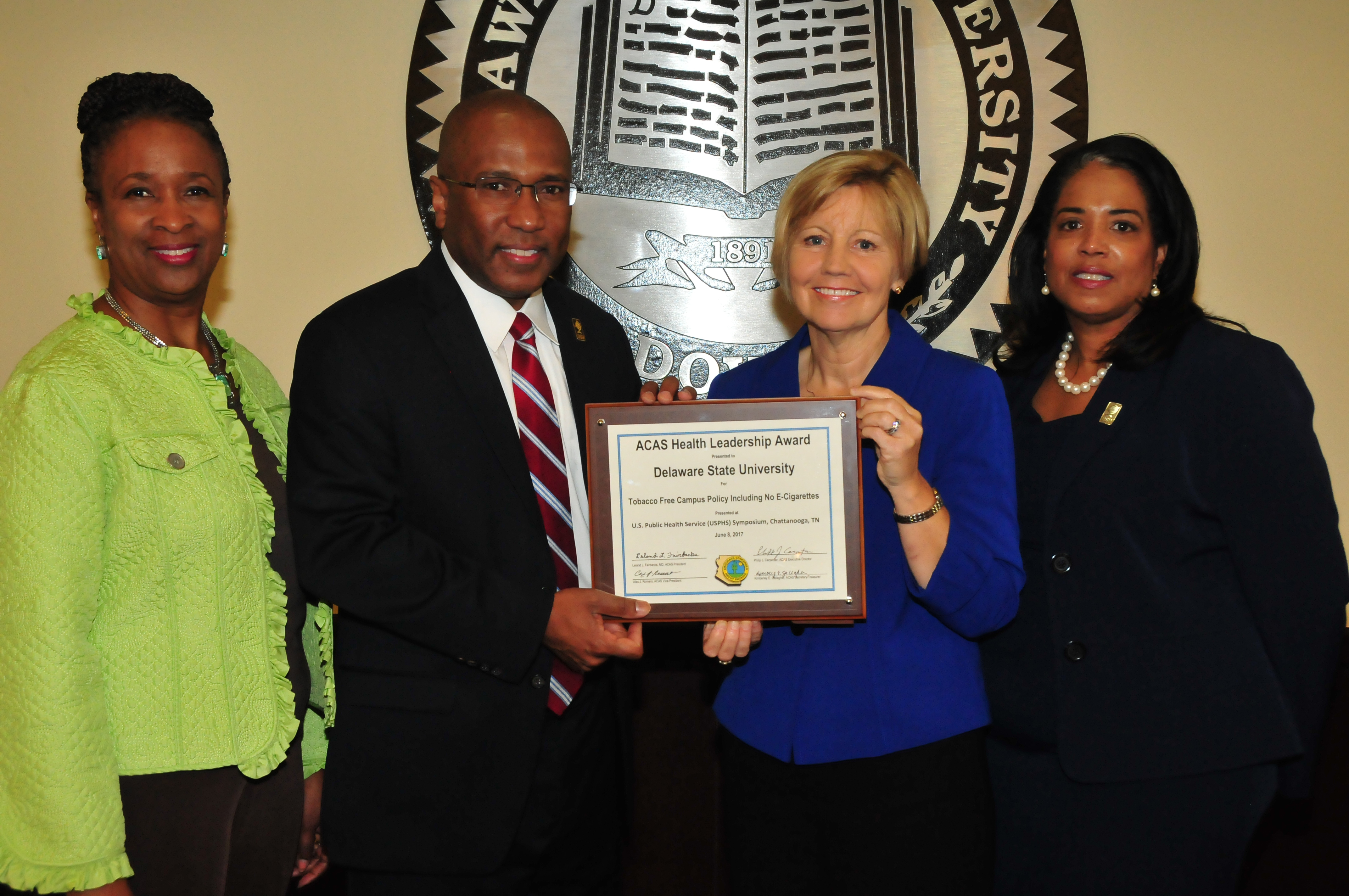 (L-r) Dr. Marsha Horton, dean of the College of Education, Health and Public Policy; DSU President Harry L. Williams; Marianne Carter, director of the Del. Center for Health Promotions; Dr. Michelle Fisher, director of DSU Health Service, display the national award DSU received for its no smoking policy on campus.