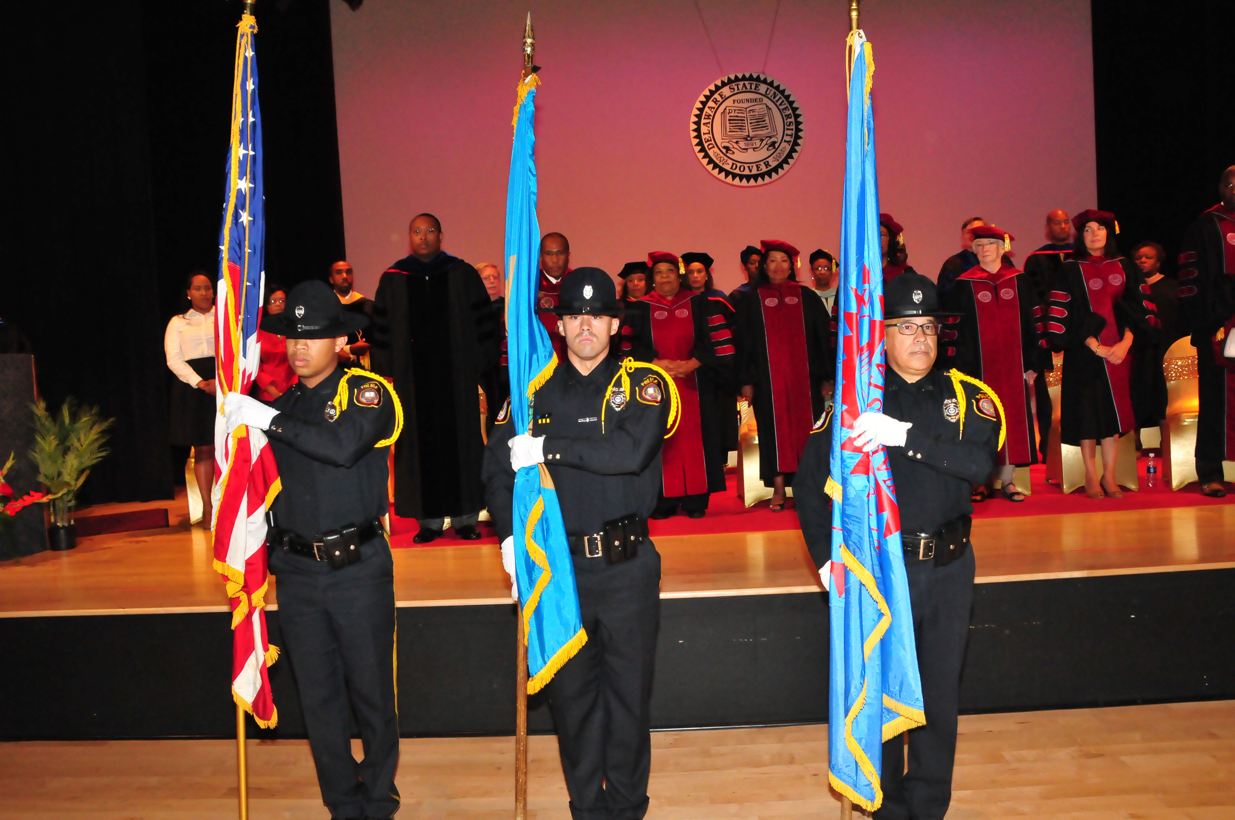 The DSU Police Honor Guard -- (l-r) Ptlm. Teddy Tyson, Ptlm. Anthony Sapienza and Ptlm. Jorge Camacho -- present the flags for the opening National Anthem during the Convocation Ceremony.