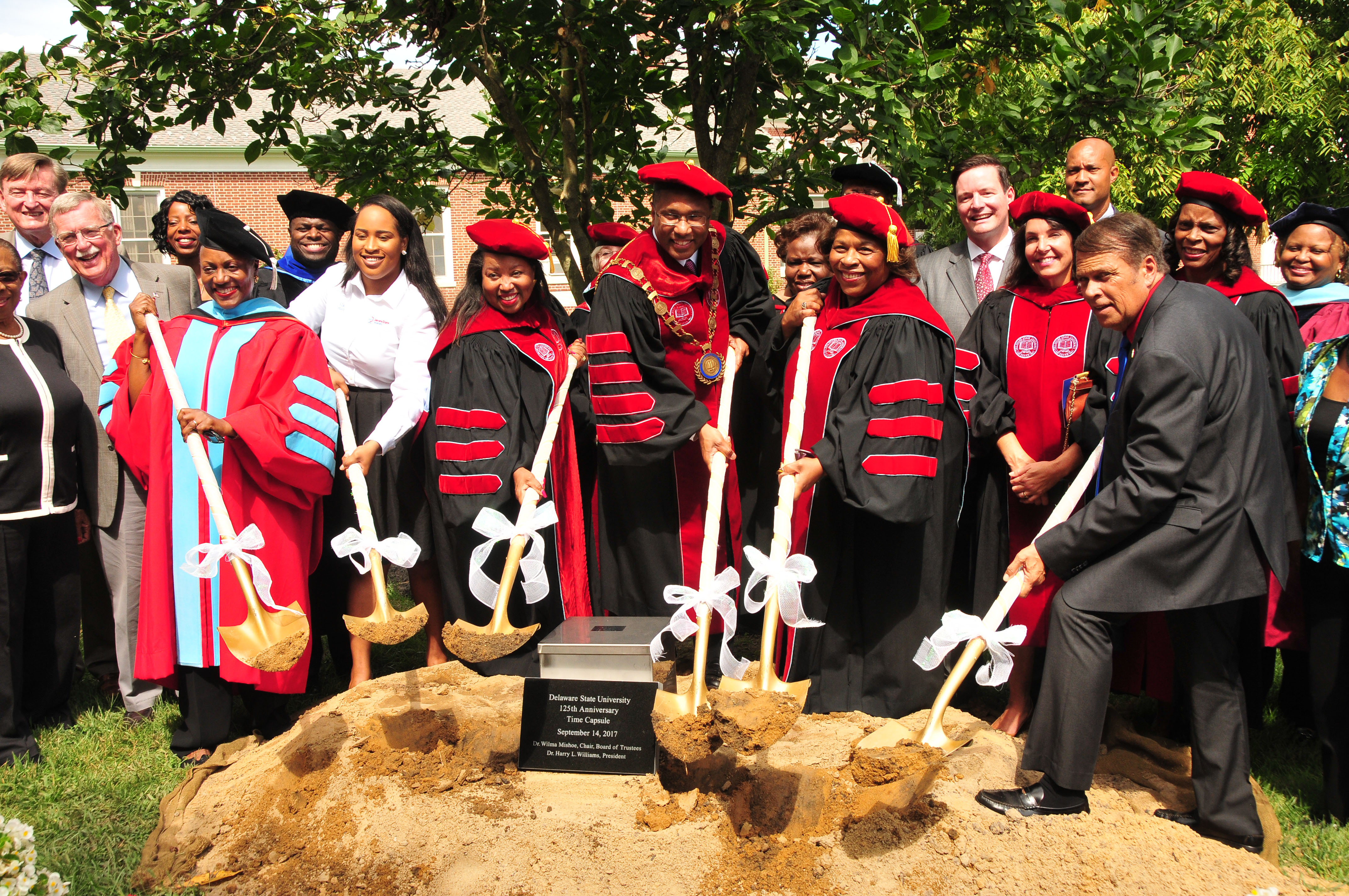 Holding shovels to begin burying the time capsule are (l-r) Dr. Vita Pickrum, VP of Institutional Advancement; SGA President Lackeeria Lewis; DSU Board Vice Chairwoman Devona Williams; DSU President Harry L. Williams; DSU Board Chairwoman Wilma Mishoe; and Dover Mayor Robin Christiansen.
