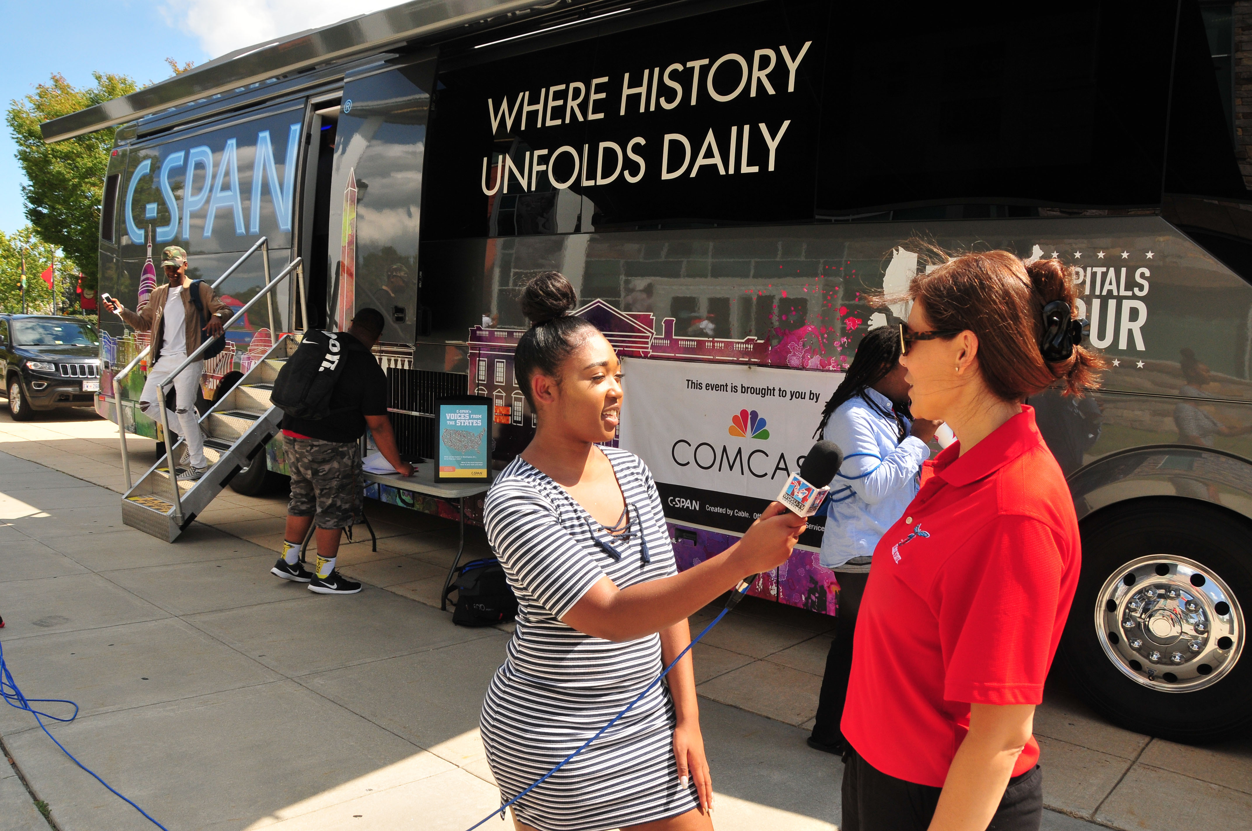 Breonté Major, interviews Renee Marine, associate professor of mass communication, in front of a C-SPAN Bus parked in front of the MLK Jr. Student Center. C-SPAN made a stop on campua to expose DSU students to the educational resources it offers and explain the mission of the public service cable network. *