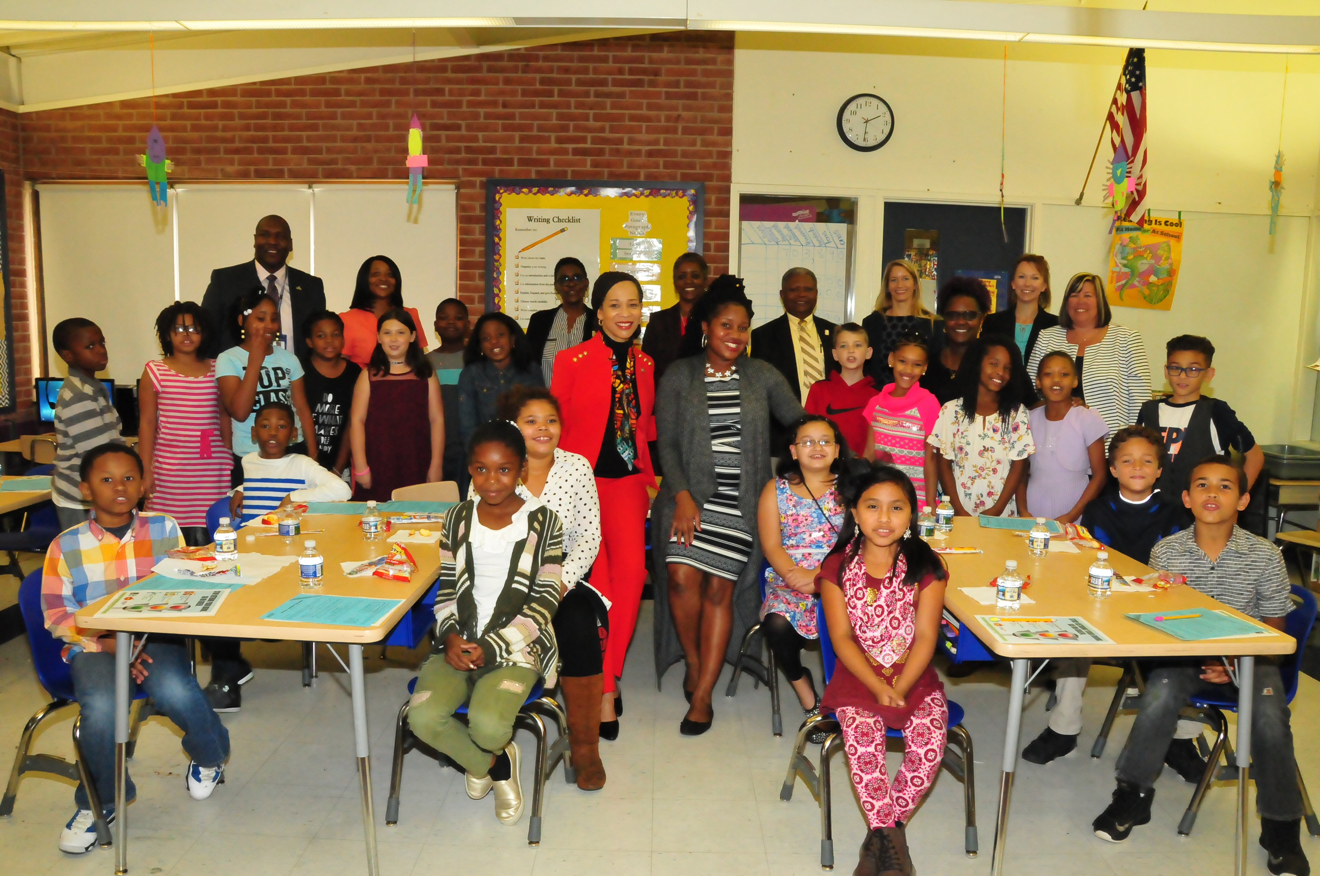 Del. Congresswoman Lisa Blunt Rochester and Ciara Martin, DSU nutrition educator (both in the center),  join students of Towne Point Elementary School and others for a photo after teaching about healthy and unhealthy drink choices.