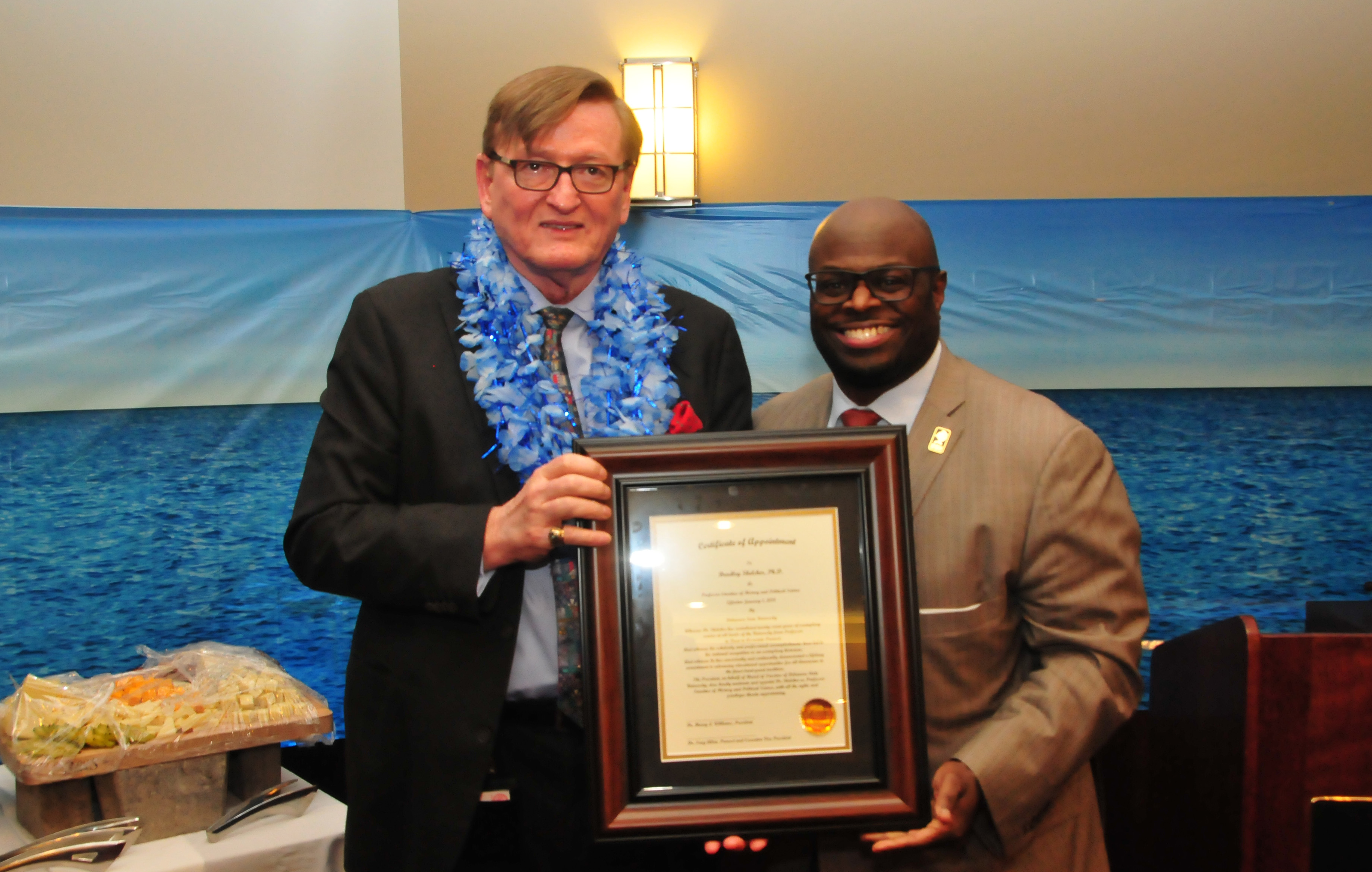 Dr. Bradley Skelcher (l) receives the University's title of "Professor Emeritus" from Provost Tony Allen. 