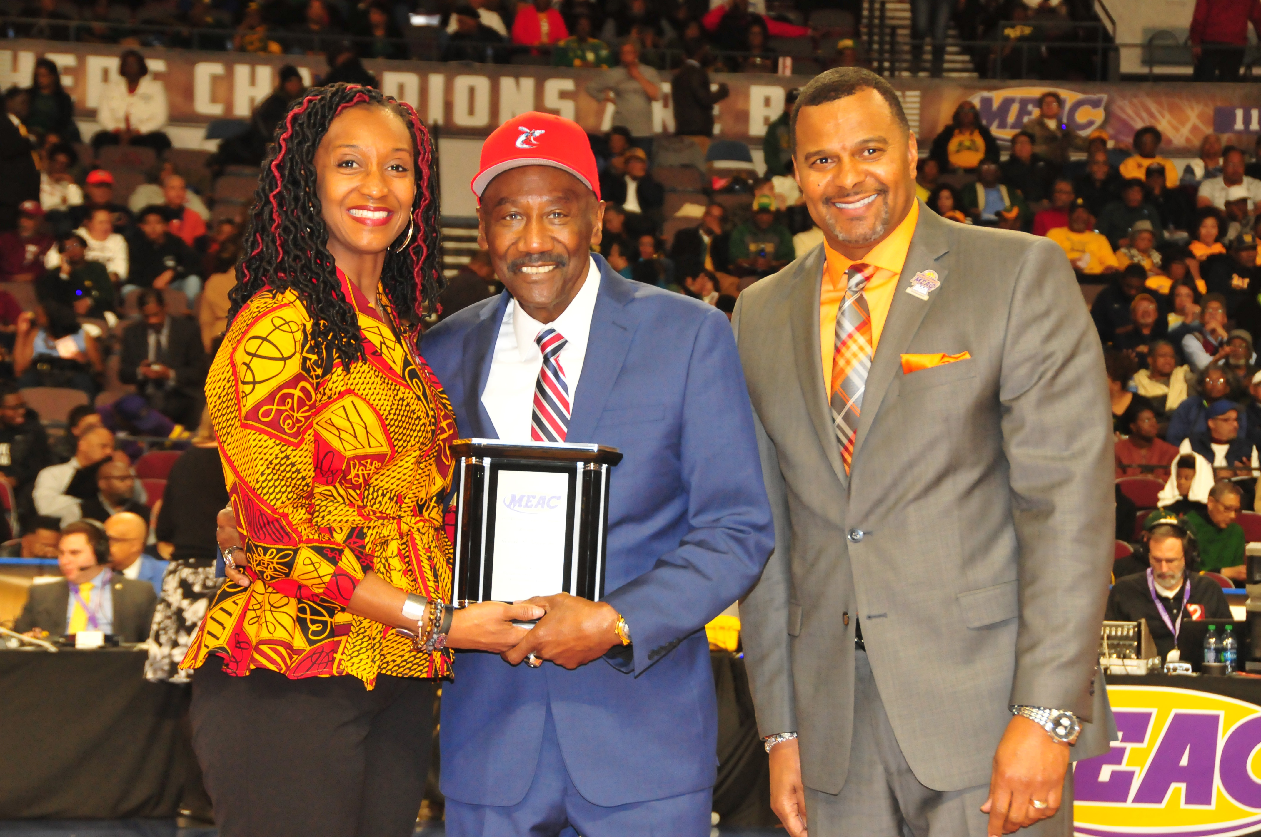Robert P. Vanderhost (center), DSC class of 1972, was among the 2018 MEAC Alumni of the Year. He is shown March 8 at the MEAC Basketball Tourney accepting the award from two conference officials.