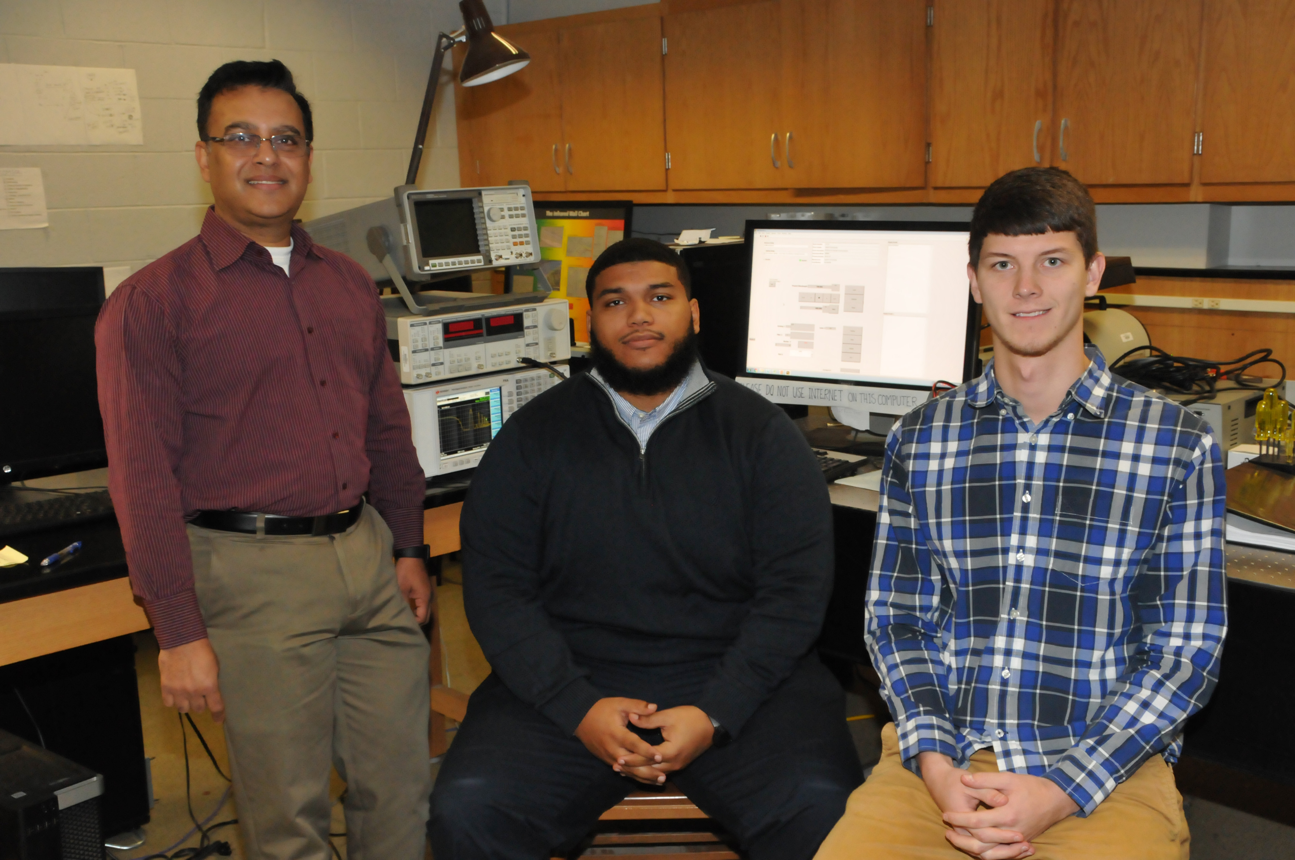 (L-r) Dr. Mukti Rana, chair of the Dept. of Physics and Engineering and the grant's principal investigator, with Danzel Hill and Andrew Voshell, undergraduate and graduate students, respectively. Both students are working with Dr. Rana on the research project.