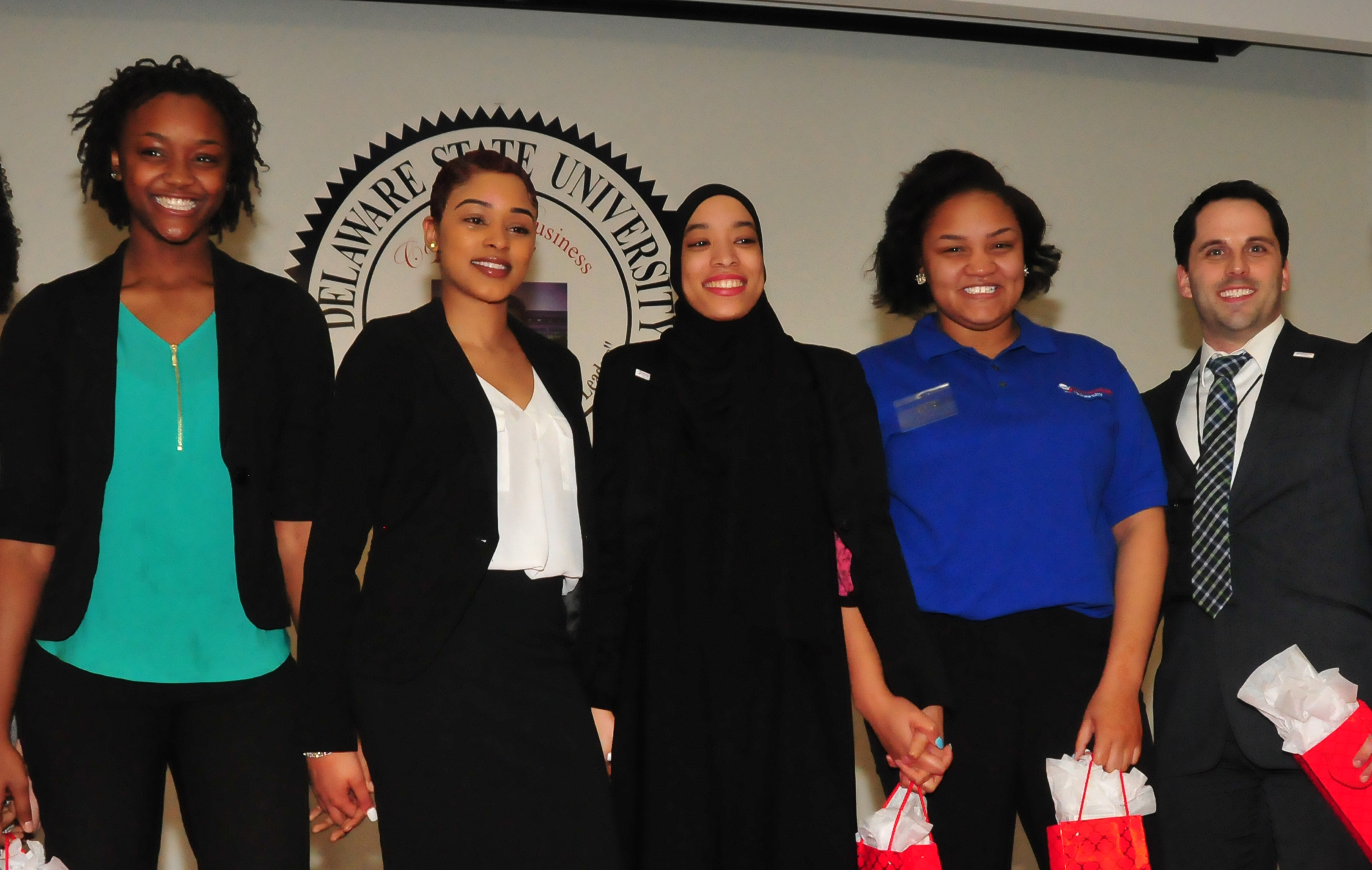 The Business Competition first-place En'Liven team: (l-r) Lashae Eden-Clemons, LaShae Billips, Alexis Sharif, Kia Abrams, along with their coach Brian Passerell. The team came up with the best plan to address homelessness.